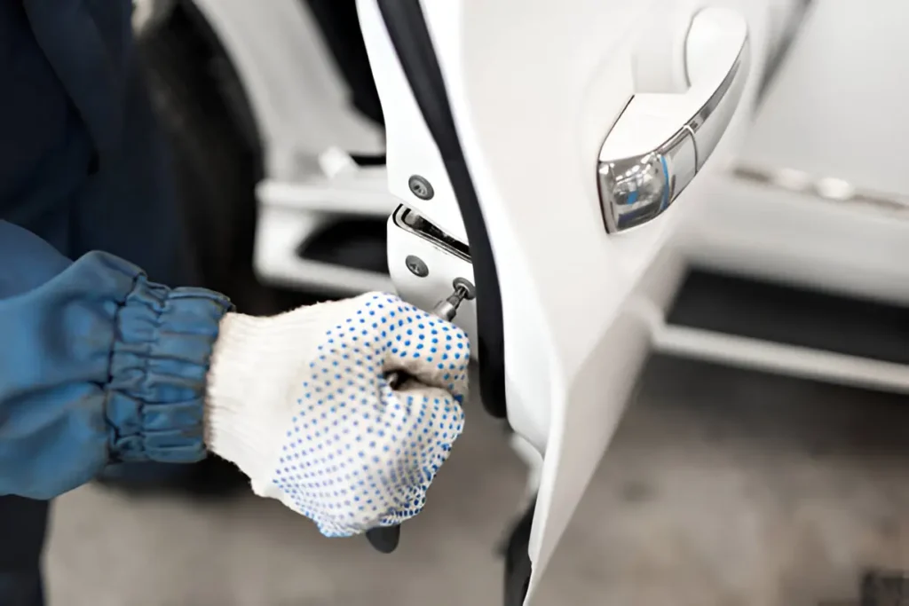 Home 11 Technician cutting car key for vehicle owner in Springfield