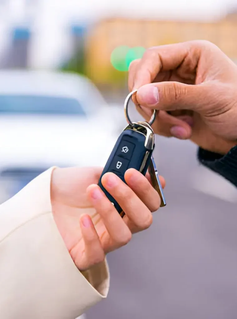 Smiling Locksmith Handing Over New Keys Friendly locksmith in Billings delivering car key replacement service